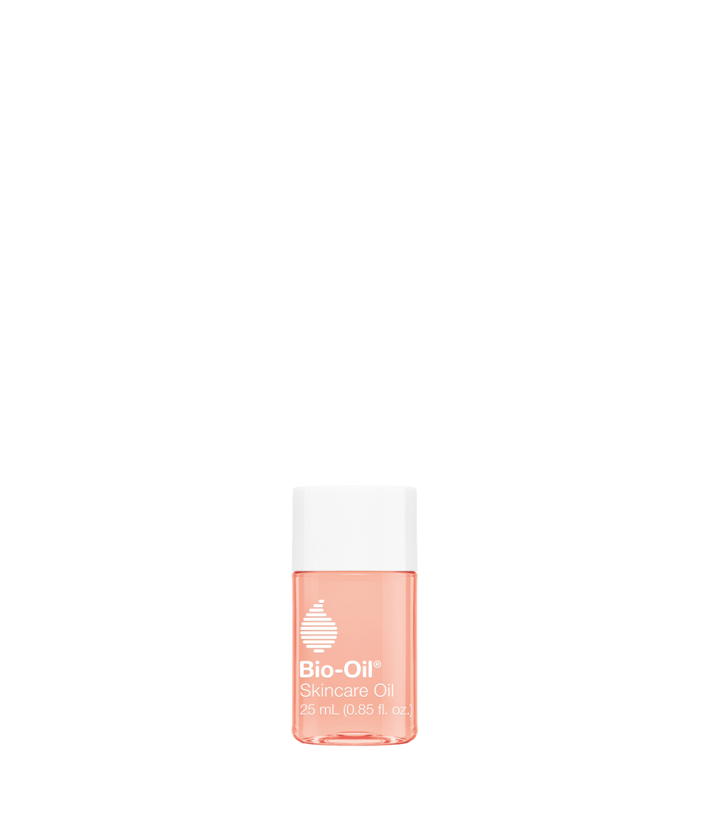 A bottle of Bio-Oil skincare oil on a black background.